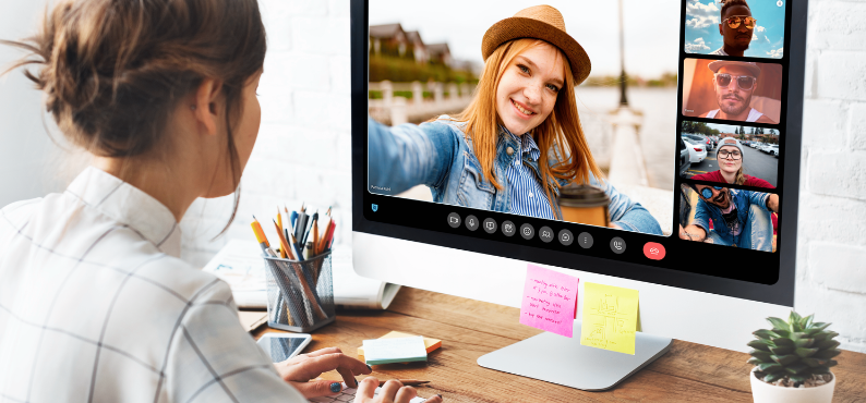 Une femme en visioconférence utilise le logiciel Linphone pour passer un appel vidéo. Elle est concentrée devant son écran.